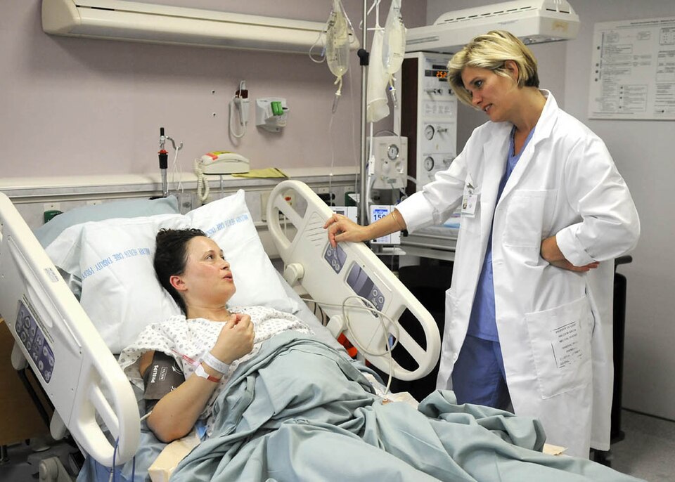 File:US Navy midwife checks on a mom.jpg